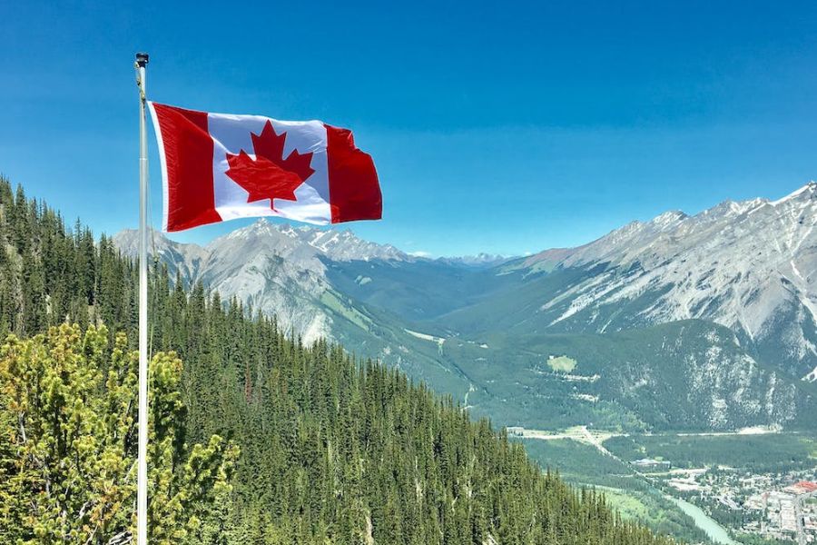 Canadian flag on top of a mountain