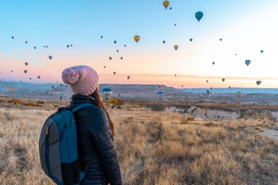 Woman looking at hot air balloons