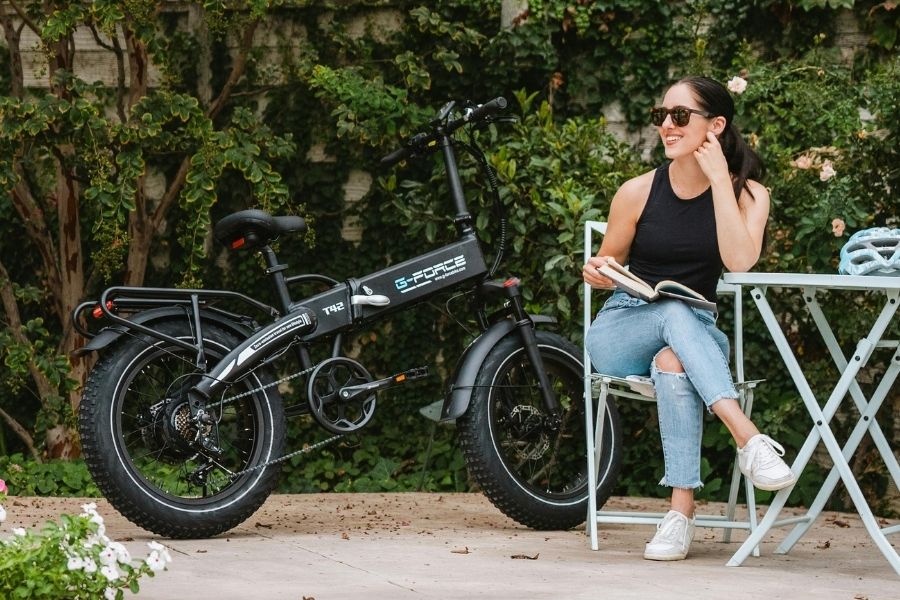 Woman sitting next to an electric bike