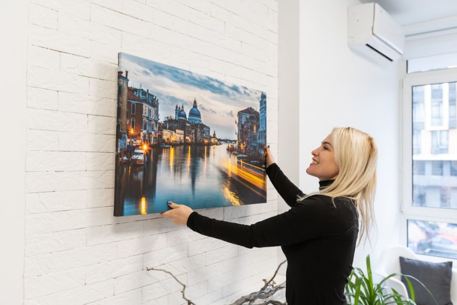 Woman hanging canvas photo